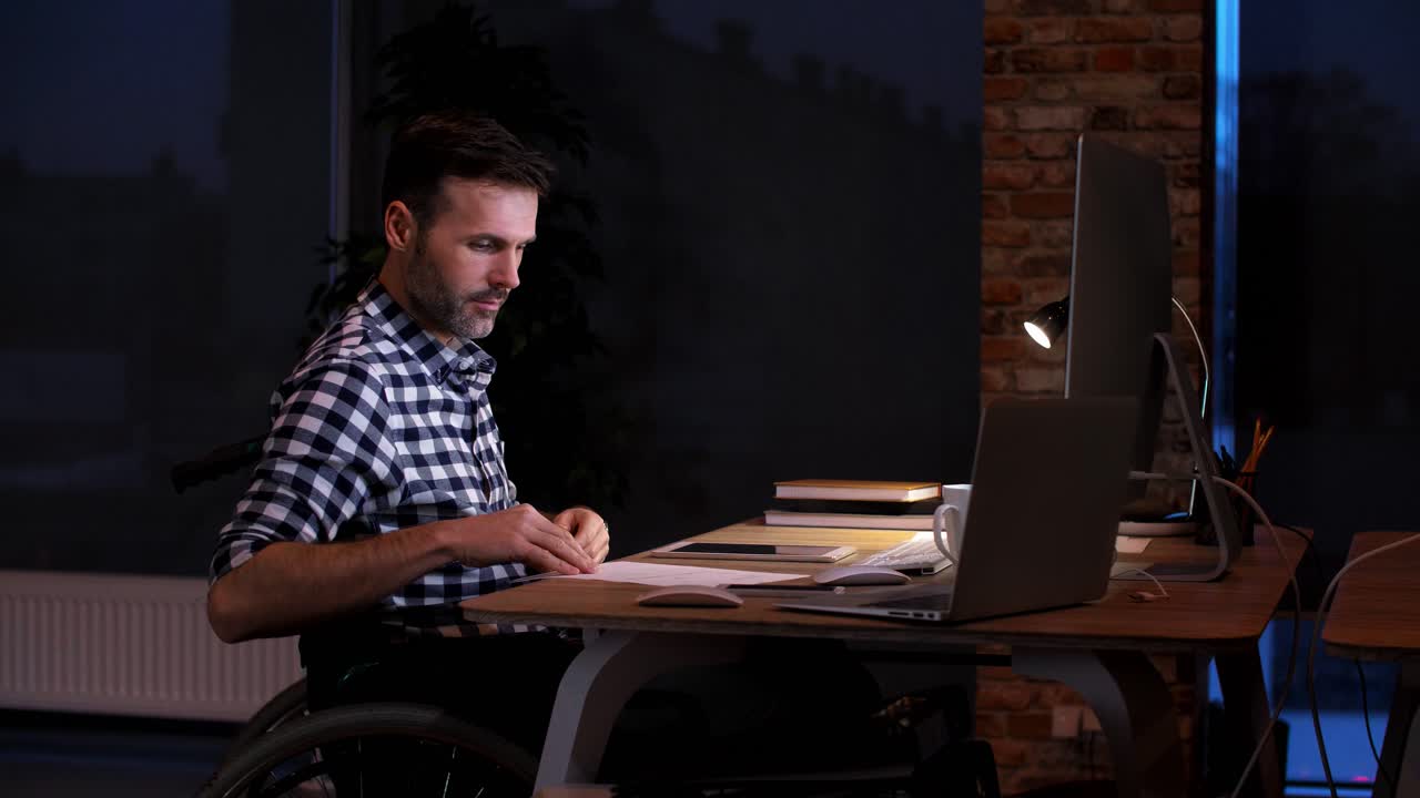 Disabled man working at night