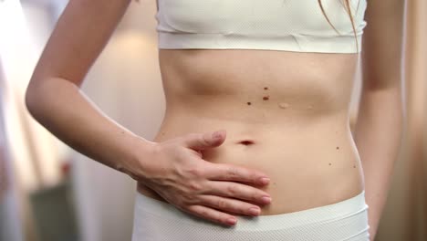 Woman-stomach-pain.-Female-stomach-ache.-Female-hand-touching-belly-pain