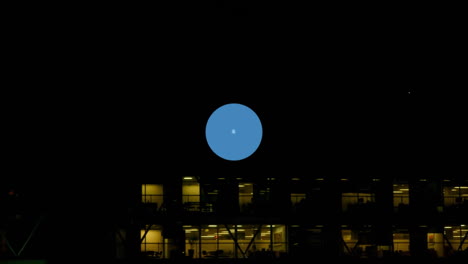 network of connected devices and music icons animation over office building at night