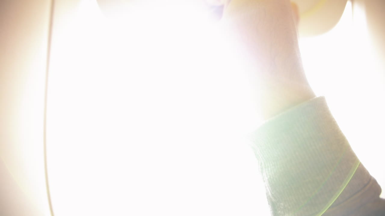 la luz brillante brilla cuando el hombre abre la cortina de la ventana dentro del avión