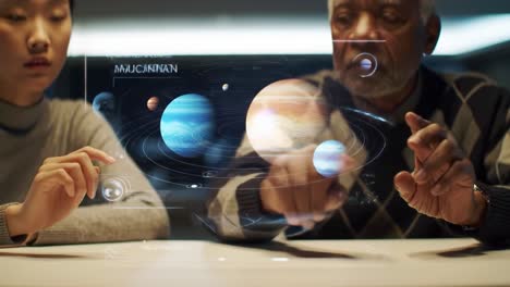 two individuals explore a virtual solar system using holographic technology. they interact with planets and cosmic elements, promoting collaborative learning in science.