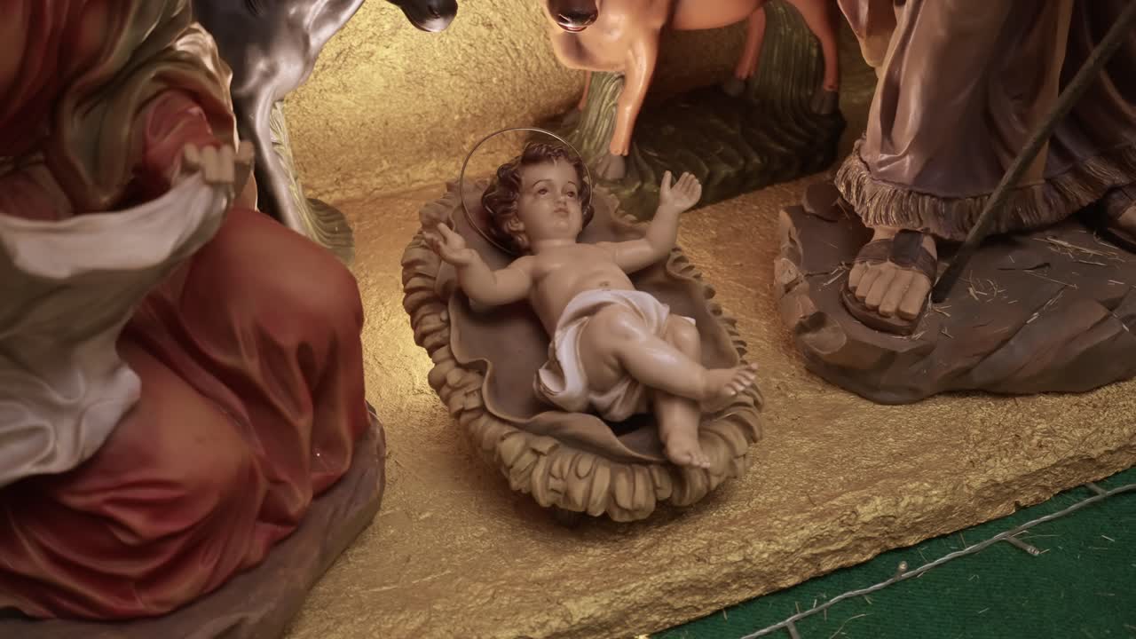 Baby Jesus figure lying in manger as part of Christmas nativity scene
