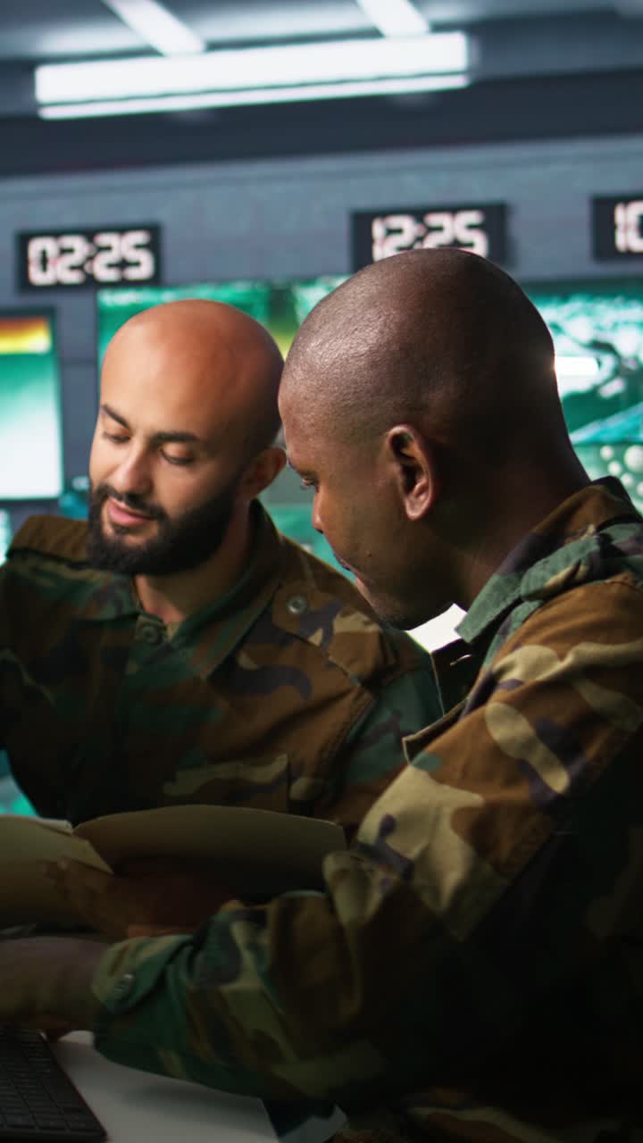 Vertical video Teamworking military agents look at intel folder files