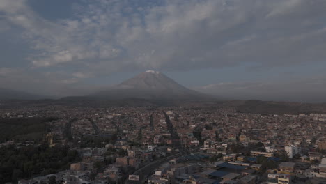 upwards moving drone shot above arequipa peru with view on the mountain near sunset time with clouds in the sky log