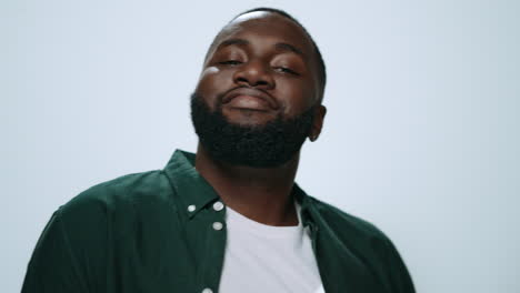 Closeup-happy-african-american-man-dancing-on-grey-background-in-studio.