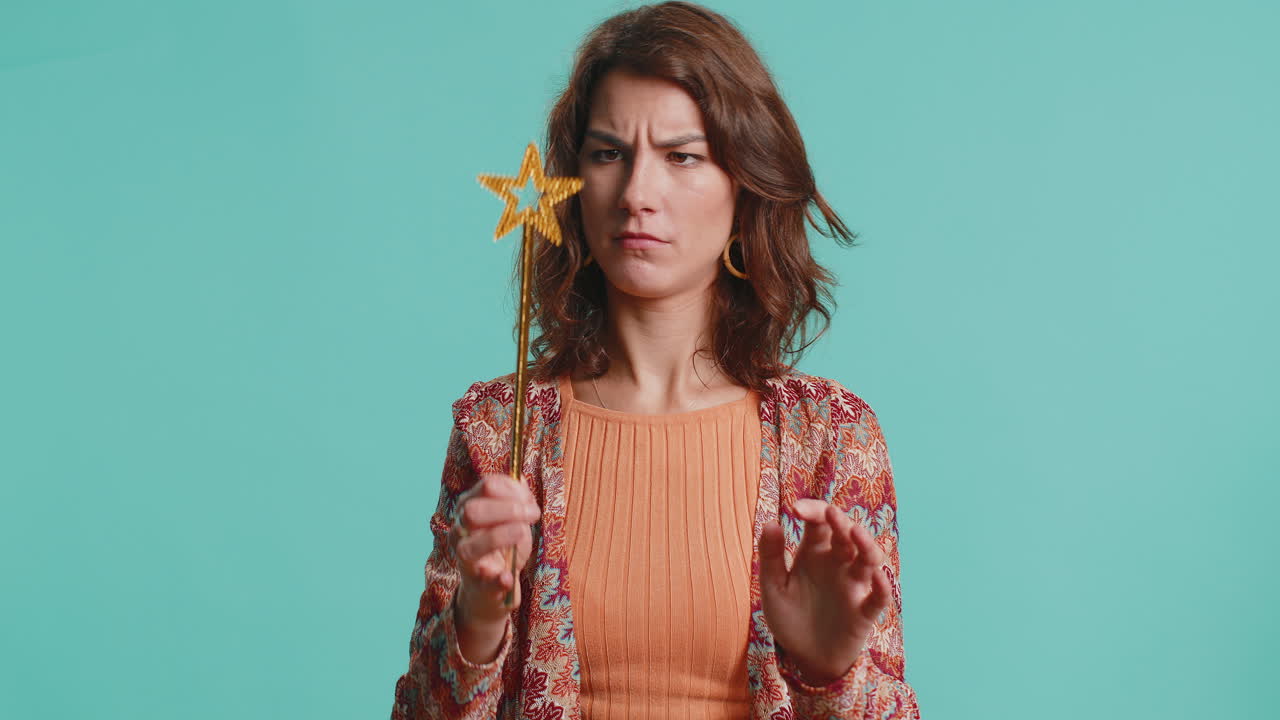 Magician witch wizard woman gesturing with magic wand making wish come true casting magician spell