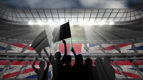 animation of silhouettes of sports fans cheering with british flag over sports stadium