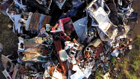 large pile of scrap metal, car parts, doors, bumper, among other remains