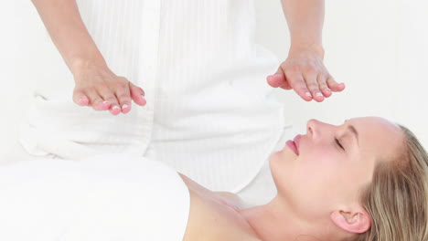 calm woman receiving reiki treatment