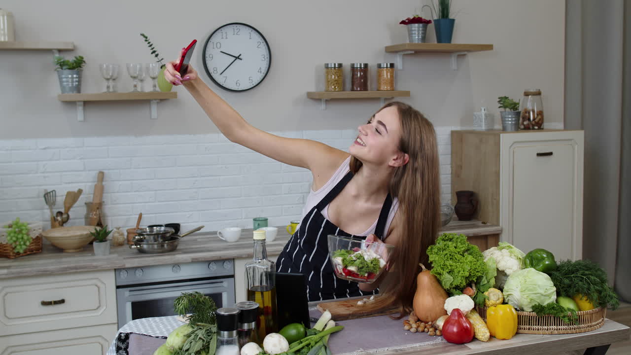 Blogger girl preparing food, taking photos on phone, making selfie to social media or video stories
