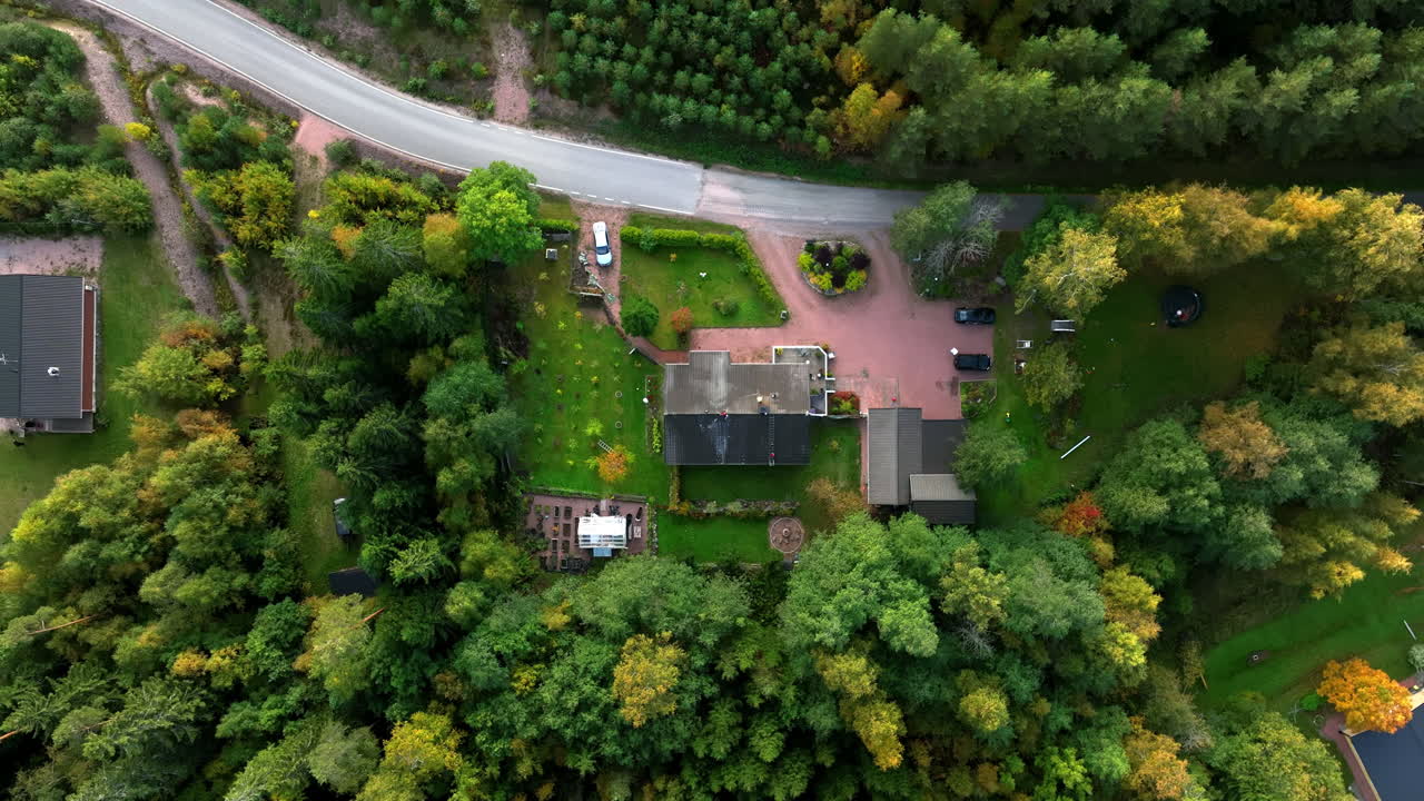 Overhead drone shot descending above a family house, autumn day in Scandinavia