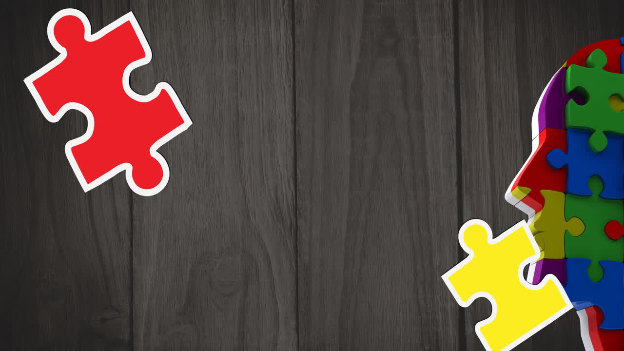 Animazione di pezzi di puzzle verdi, gialli e rossi che cadono su modello di testa umana con puzzle