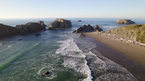 4K-aerial-drone-shot-overlooking-waves-at-Bandon,-Oregon-beach