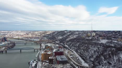 drone aerial view of snow covered mount washington in pittsburgh