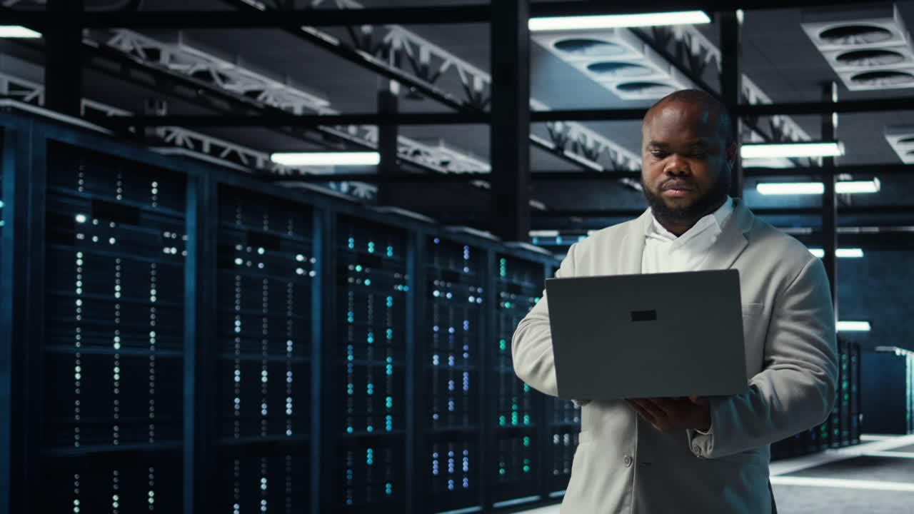 Vertical video Data center engineer analyzing equipment performance, resolving technical issues