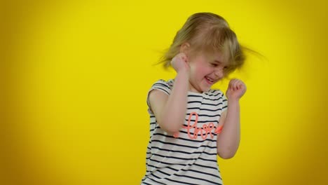 Little-blonde-kid-child-girl-celebrate-success-win,-rejoices-doing-winner-gesture-say-Yes,-dancing