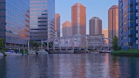 Evening-Tokyo,-Tsukuda,-Toyosu-skyscrapers-and-bridge-the-Sumida-River