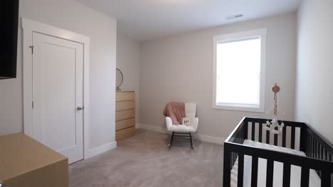 empty baby's room with a crib and cute carpet on the floor