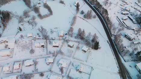 a snow-covered residential roofs during winter of sunrise