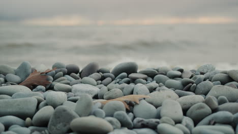 waves break on the pebbles on the lake.