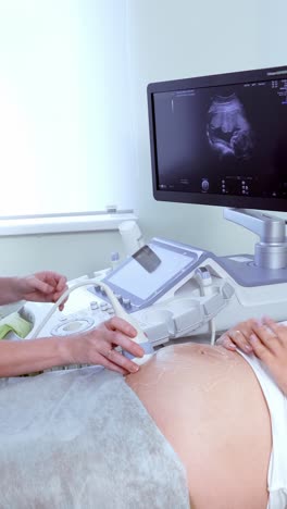 expectant mother receiving ultrasound examination in a medical clinic with advanced equipment