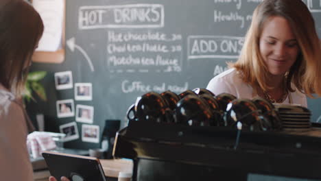 happy barista woman serving customer buying croissant in busy coffee shop cafe enjoying friendly service