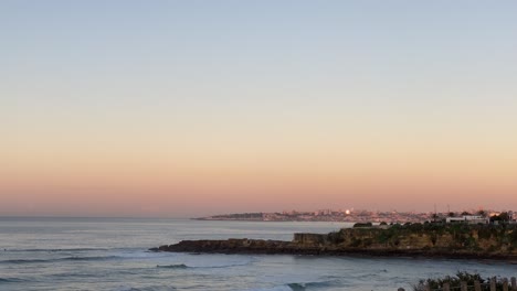 vivid sunrise or sunset over ocean waves and cascais marine in portugal atlantic guincho coast, near sintra estoril cascais wide shot