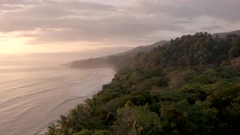 Jungle-meets-the-ocean-at-Punta-Uvita-Beach-in-western-Costa-Rica-Central-America-during-sunset,-Aerial-flyover-shot
