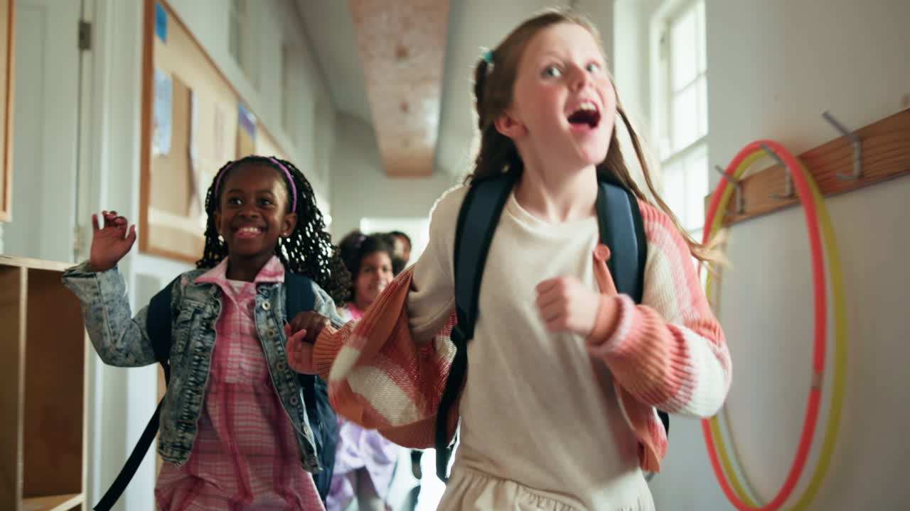 Joyful Schoolgirls Running in Hallway