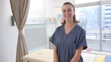 Portait-of-caucasian-female-physiotherapist-smiling-at-rehab-center