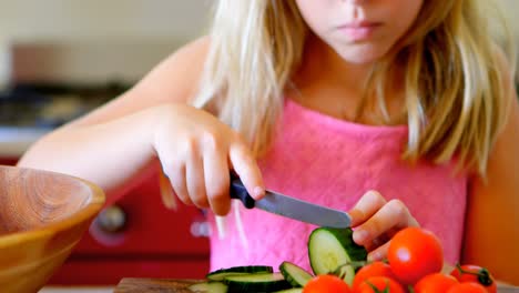 Girl-cutting-vegetable-in-kitchen-4k