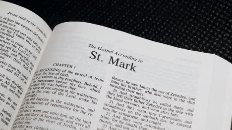 close up shot of bible page turning to the book of mark