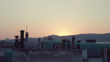 establishing timelapse shot of sunset over mountains seen from rooftop