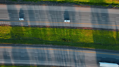 lorries and cars drive by the highways to both sides. top view on the roads at daytime.