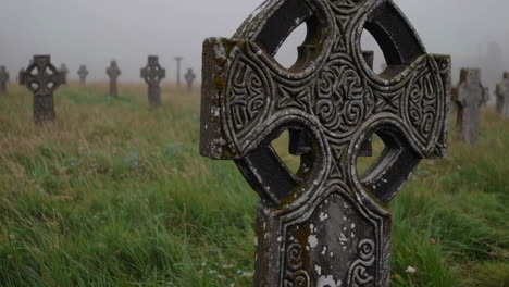 ancient celtic crosses in a misty graveyard