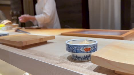 chef skillfully prepares sushi in a restaurant