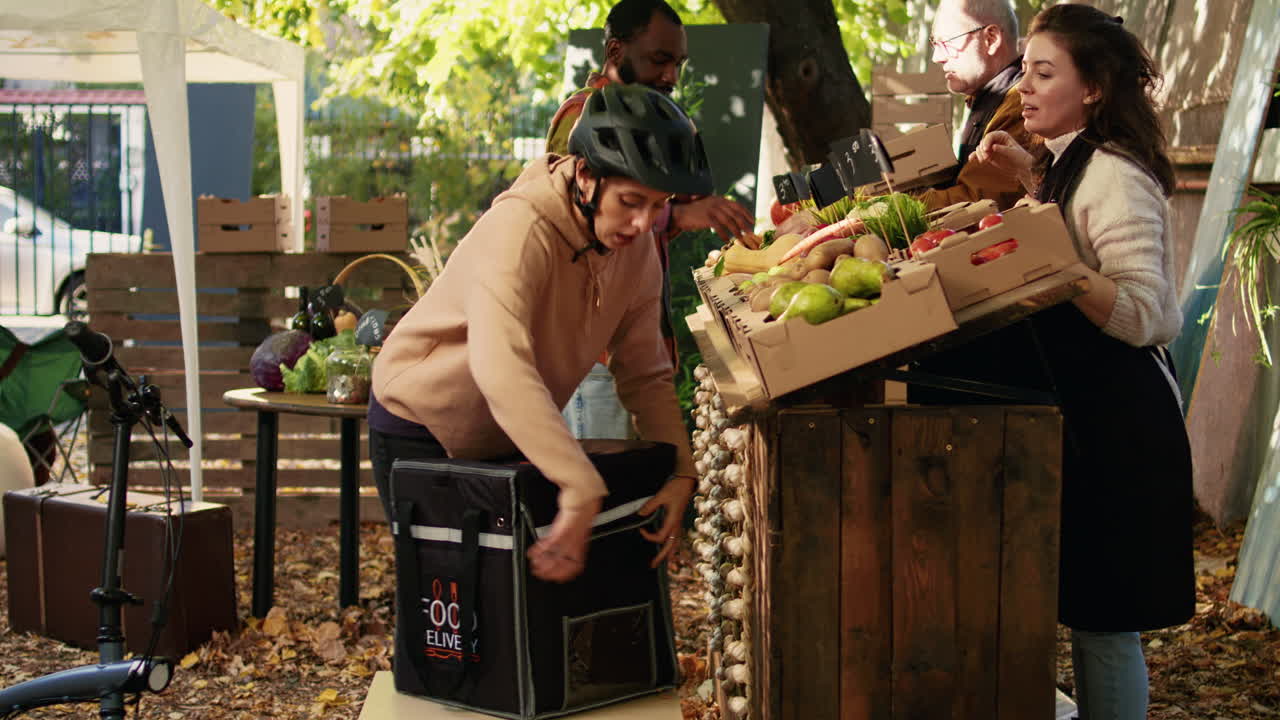 A delivery person picks up food from a farmers market