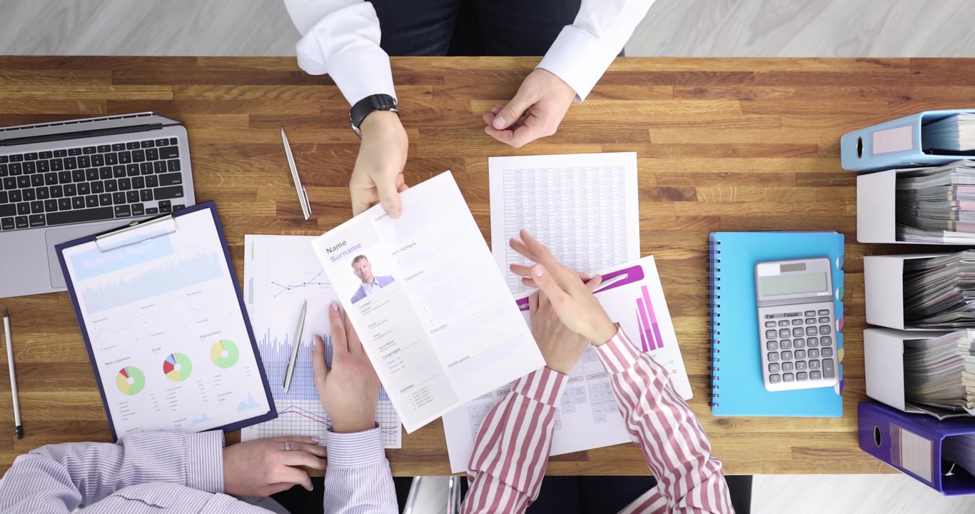 Partners shake hands over contract creating team agreement