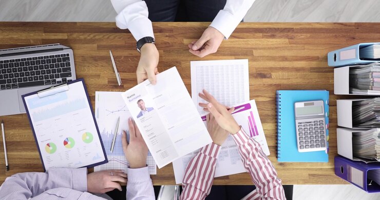 Partners shake hands over contract creating team agreement