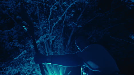 person in silhouette at night with blue light