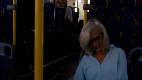 Mature-woman-using-laptop-while-travelling-in-bus-4k