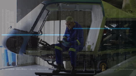 technician using tablet in automotive workshop, displaying animated data overlays on chassis