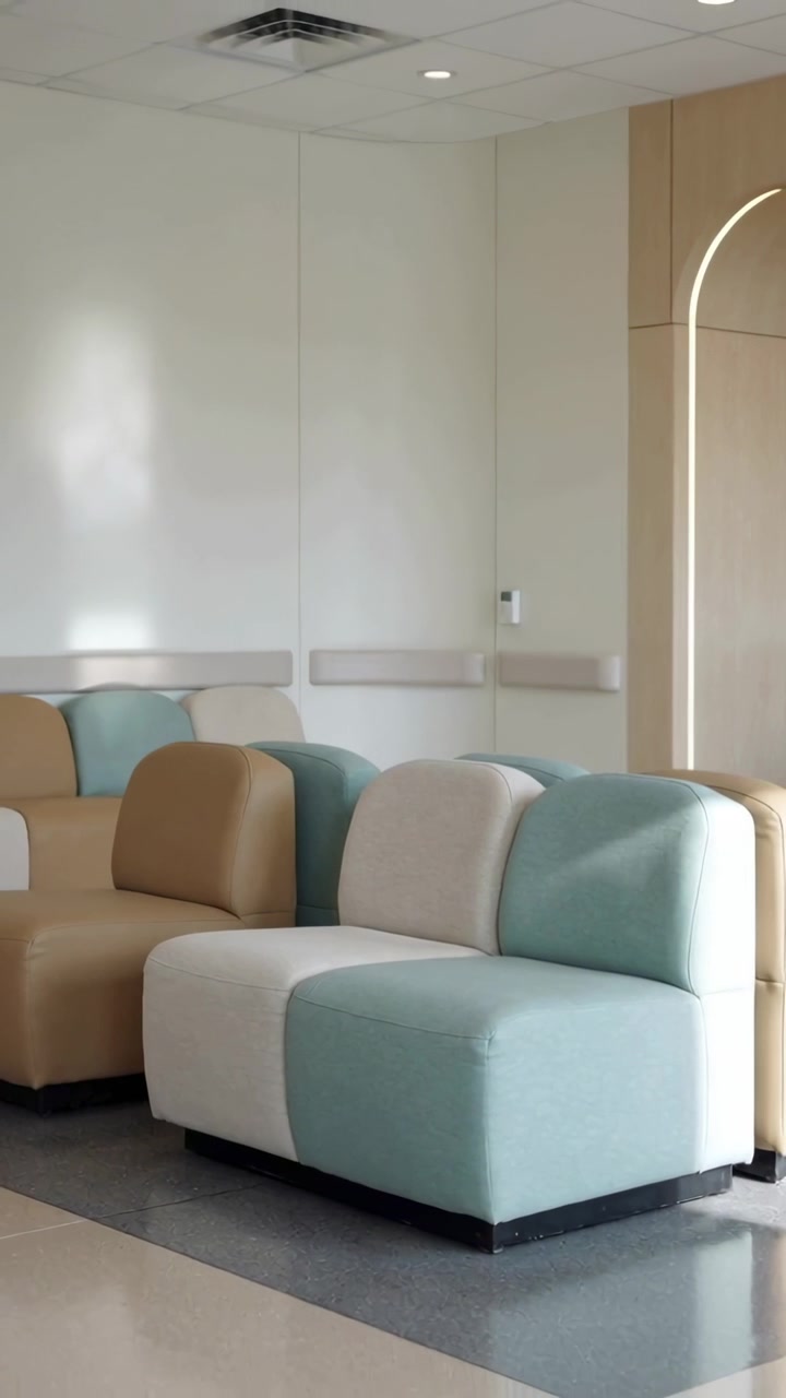 Vertical video: Panning camera revealing modular two-seat sofa in waiting area, showing wooden arch