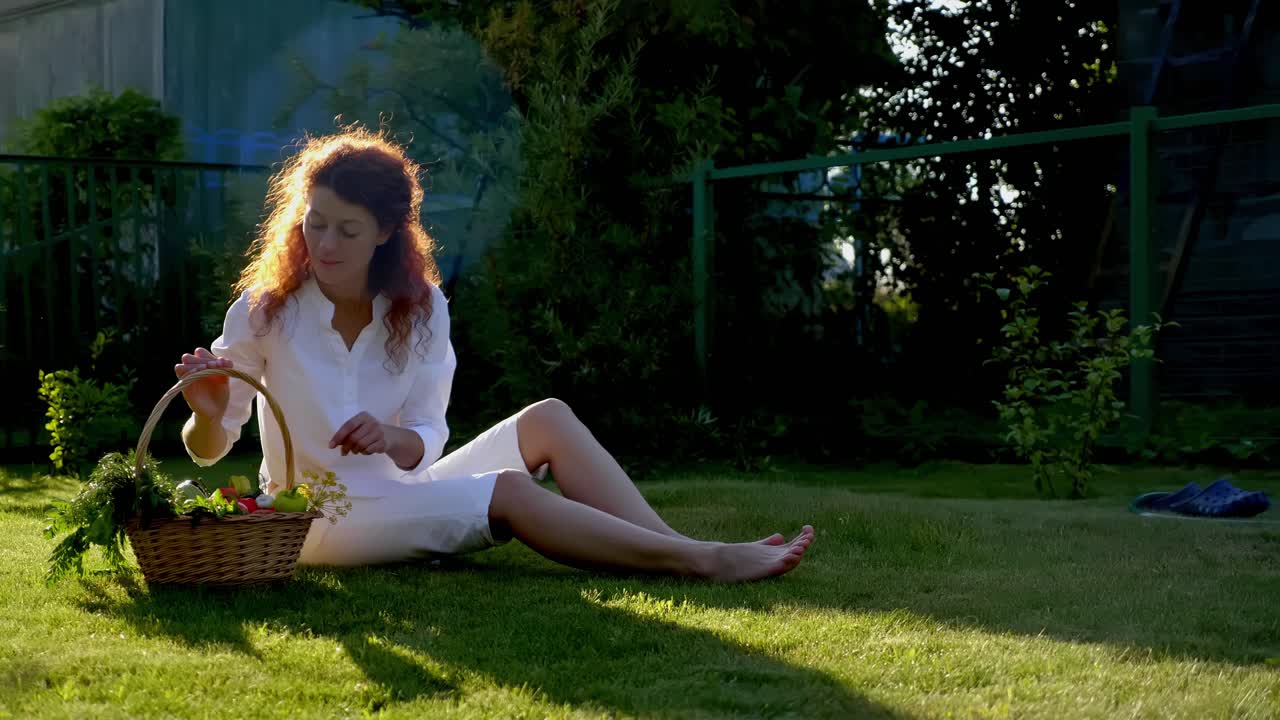 Woman enjoying an apple in a garden