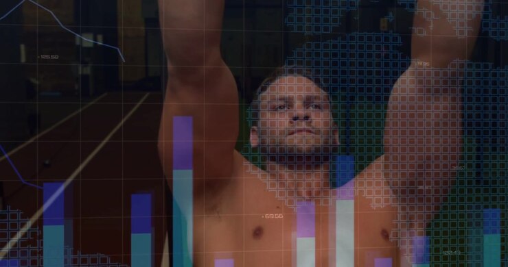 Atleta maschio che afferra gli anelli e tira, allenandosi in palestra e generando grafici di fitness per il monitoraggio.