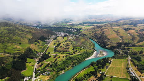 Pinders-Pond-Freedom-Camping-and-deep-blue-river-in-New-Zealand,-aerial-view