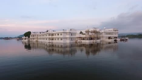 the taj lake palace on lake pichola in udaipur india is seen at sunset 1