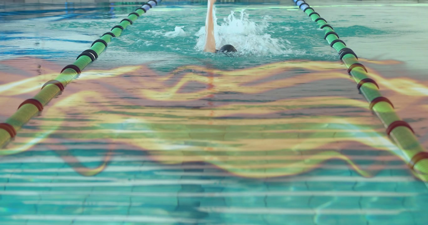 Woman swimmer appearing pool end amid lane dividers, powering freestyle strokes for sports training