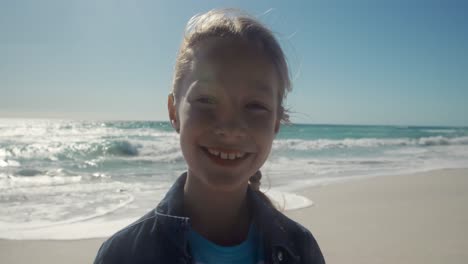 young girl looking at the camera at the beach