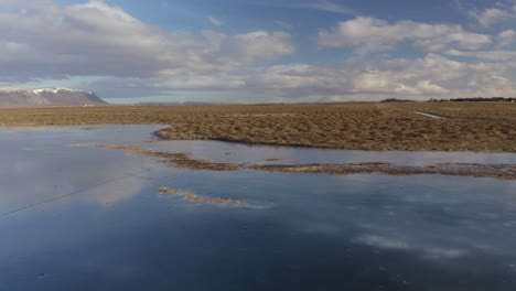 scenic view of peaceful river olfusa in iceland under the bright cloudy sky - wide shot